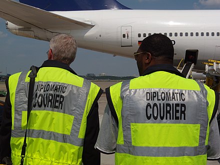 A_Diplomatic_courier_ensures_that_palletized_U.S._Diplomatic_pouch_material_is_properly_unloaded_from_an_aircraft_at_Dulles_International_Airport_in_Chantilly,_VA,_June_8,_2009